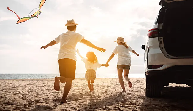 family running on a beach